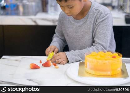 happy kid boy making a cake