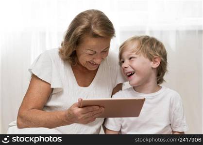 happy kid grandma with tablet