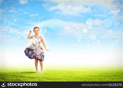 happy kid jumping. Photo of little girl jumping and raising hands against nature background