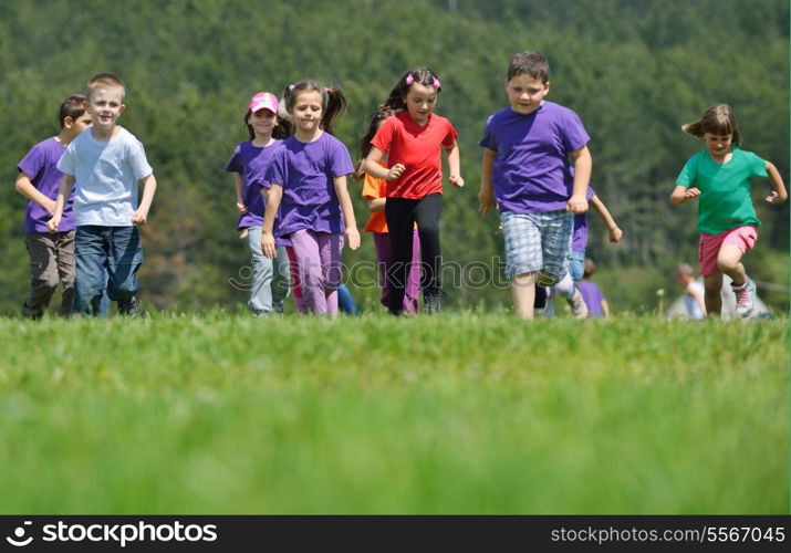 happy kids group have fun in nature outdoors park