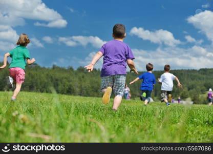 happy kids group have fun in nature outdoors park