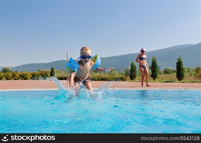 happy kids have fun on outdoor swimming pool at beautiful aquapark