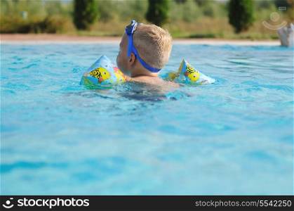 happy kids have fun on outdoor swimming pool at beautiful aquapark