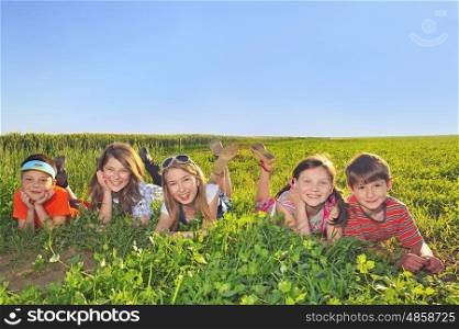 happy kids laying in the summer field