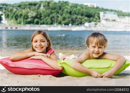 happy kids relaxing air mattresses river coast summertime