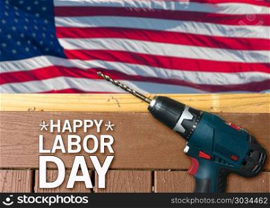 Happy Labor Day background with deck and drill. Drill on composite deck in front of USA flag for Labor Day background poster. Happy Labor Day background with deck and drill