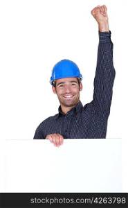 Happy laborer with fist up in the air