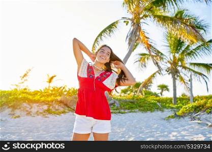 Happy latin beautiful girl in caribbean palm trees sunset beach