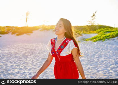 Happy latin beautiful girl walking in caribbean palm trees beach