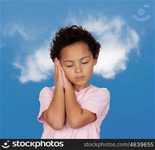 Happy latin child sleeping with a blue sky of background