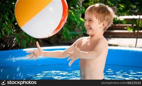 Happy laughing boy cathcing beach ball and playing in swimming pool.. Happy laughing boy cathcing beach ball and playing in swimming pool