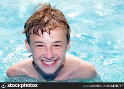Happy laughing boy in a pool