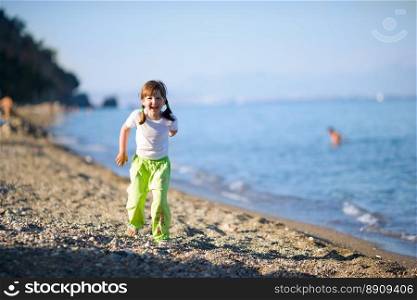 Happy laughing girl Running on beach near sea