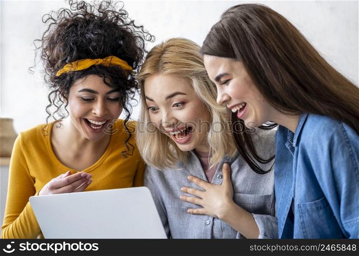 happy laughing women using laptop