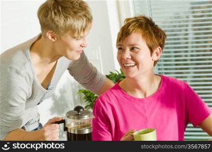Happy lesbian couple on the breakfast table