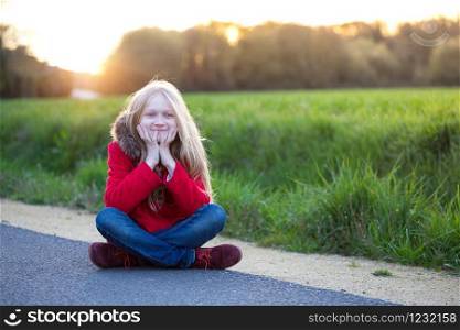 Happy little beautiful girl outdoor at sunset