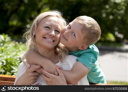 Happy Little boy and mother in summer day