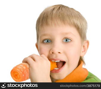 Happy little boy biting a carrot