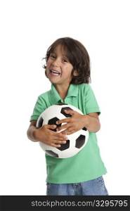 Happy little boy holding a soccer ball on white background