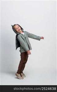 happy little boy with arms outstretched on white background, studio shooting. boy on white background
