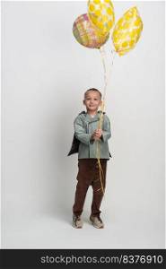 happy little boy with balloon on white background, studio shot. boy on white background