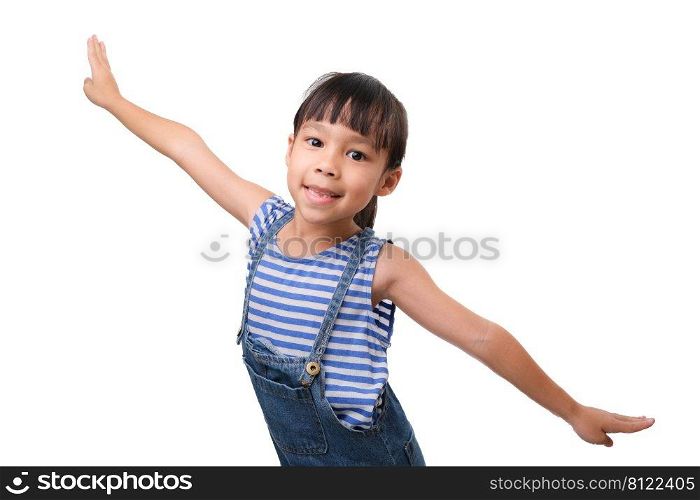 Happy little carefree girl smiling and balancing standing on one leg with her arms outstretched as if flying on a white background.