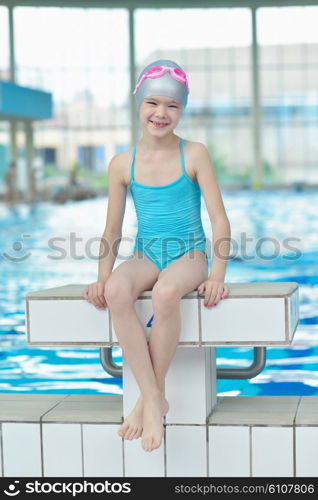 happy little child portrait on swimming school classes and recreation at indoor pool