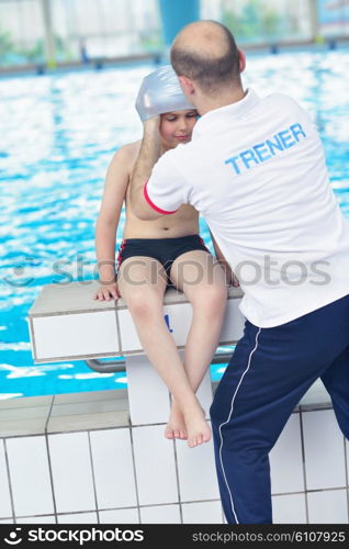 happy little child portrait on swimming school classes and recreation at indoor pool