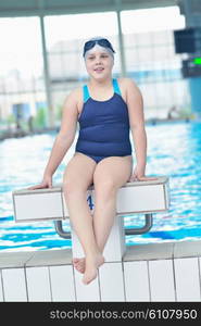 happy little child portrait on swimming school classes and recreation at indoor pool