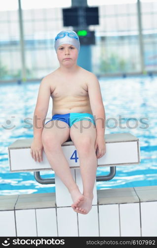 happy little child portrait on swimming school classes and recreation at indoor pool