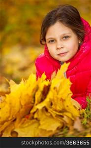 happy little girl have fun playing with fallen golden leaves