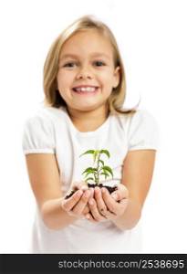Happy little girl showing a plant on her little hands