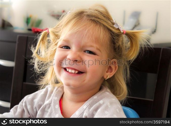 Happy little girl smiling at the camera with a cheese smile