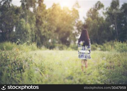 Happy little girl standing in the meadow