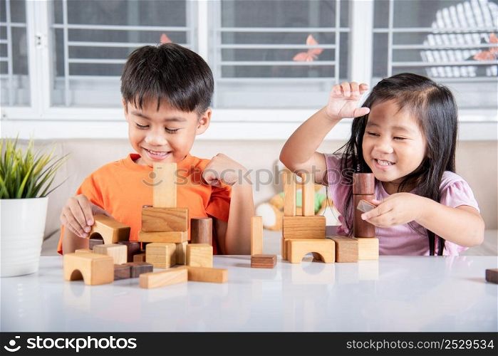 Happy little kids play wood block stacking board game at home, Children boy and girl playing with constructor wooden block, childhood activities learning creative, toys for preschool and kindergarten