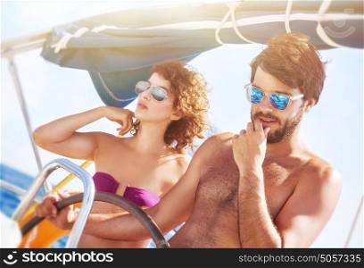 Happy lover driving sailboat, handsome captain with his cute girlfriend at the wheel of water transport, active lifestyle, interesting summer vacation