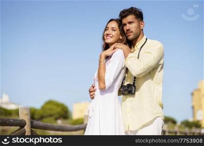 Happy loving couple looking at the horizon in a natural area. Happy couple looking at the horizon in a natural area