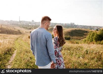 happy loving couple on the mountain. Happy couple faces skyline at city. Top view point overlooking the mountains. holidays, vacation, love and friendship concept.. happy loving couple on the mountain. Happy couple faces skyline at city. Top view point overlooking the mountains. holidays, vacation, love and friendship concept