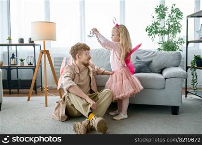 Happy loving young dad play with excited little daughter, funny game activity at home on family weekend. Happy loving young dad play with excited little daughter
