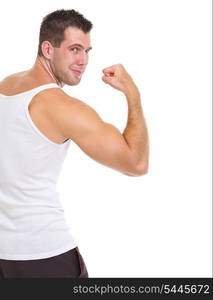 Happy male athlete showing biceps