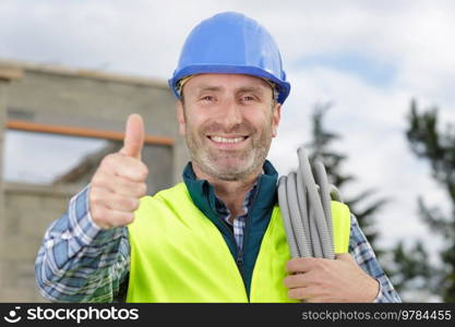 happy male builder showing thumb up