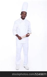 Happy male chef holding rolling pin