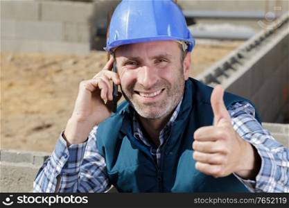happy male construction showing thumb up