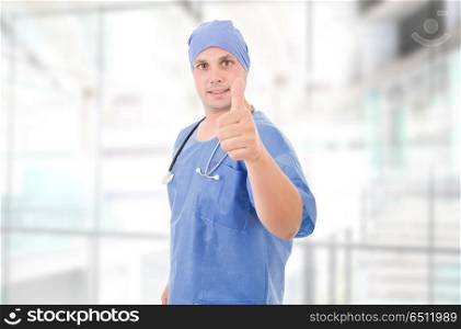 Happy male doctor showing thumbs up at the hospital. doctor