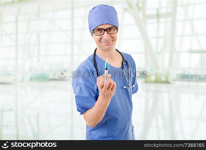 happy male doctor with a syringe, at the hospital