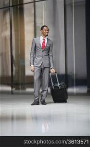 Happy male executive with luggage on a business trip