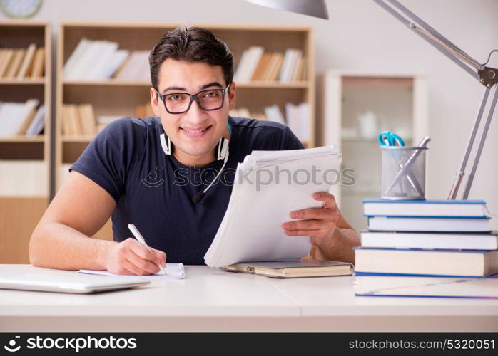 Happy male student preparing for his exams