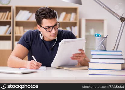 Happy male student preparing for his exams