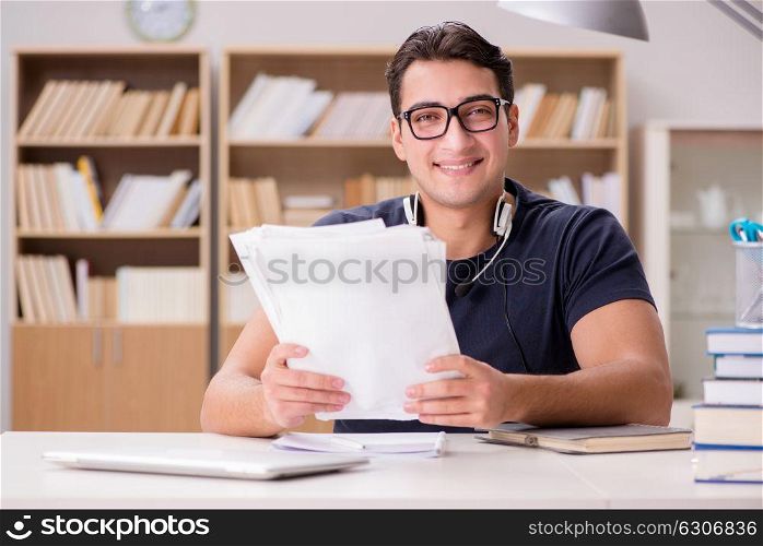 Happy male student preparing for his exams