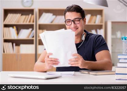 Happy male student preparing for his exams